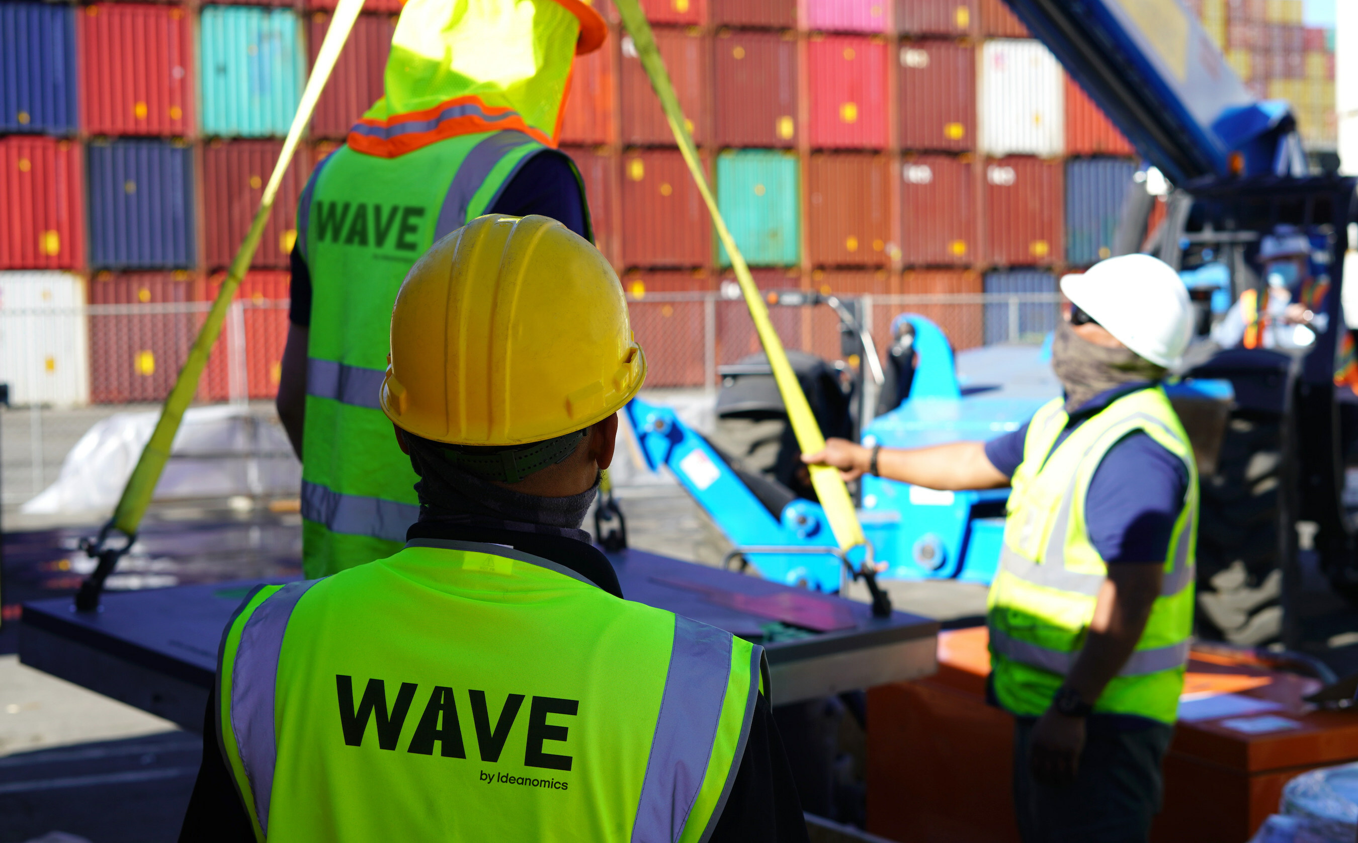 A team installs a Wave charging pad at the Port of Los Angeles