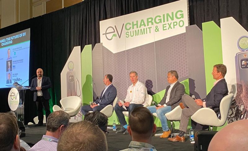 Gil Tal of the University of California, Berkeley (standing) speaks during the panel discussion at panel discussion at the EV Charging Summit & Expo in Las Vegas. Seated (left to right) are: Oscar Rodriguez of NovaCharge - Electric Vehicle Charging Solutions, Andreas Lips of Shell Recharge Solutions, Vic Shao of bp pulse, and Ethan Sprague FreeWire Technologies.